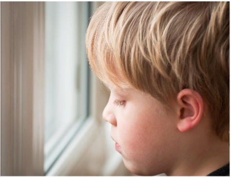 Boy looking out of window